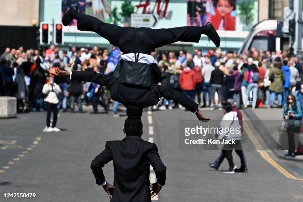 Crowds throng Princes Street as two performers promote their show during the Edinburgh Festival Fringe, on July 17 in Edinburgh, Scotland.