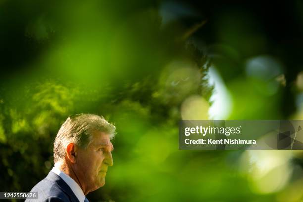 Sen. Joe Manchin speaks to members of the press following the signing of H.R. 5376, the Inflation Reduction Act of 2022, into law in the State Dining...