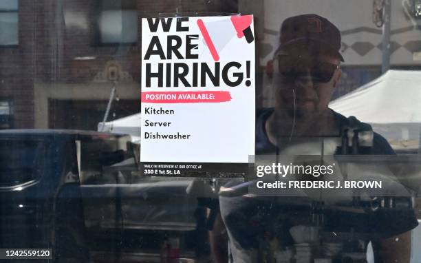 We Are Hiring" sign is posted in front of a restaurant in Los Angeles, California on August 17, 2022. - "Help Wanted" ads are proliferating across...