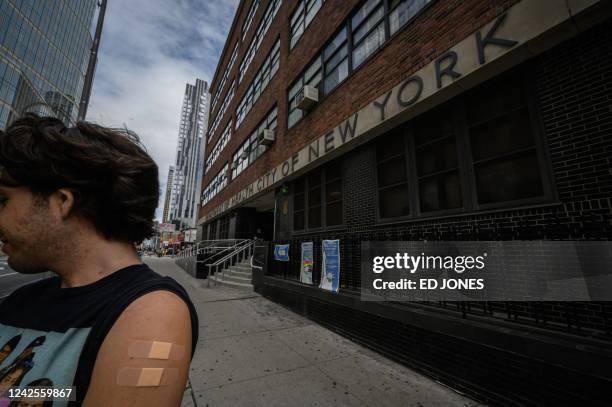 Man, who wished to remain anonymous, displays his arm where he received a polio vaccination, outside a health clinic in Brooklyn, New York on August...