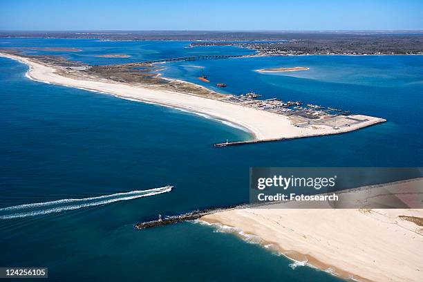 aerial view of boat entering shinnecock bay in new york. - north cove stock pictures, royalty-free photos & images