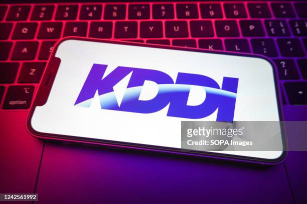 In this photo illustration, KDDI logo seen displayed on a smartphone screen.