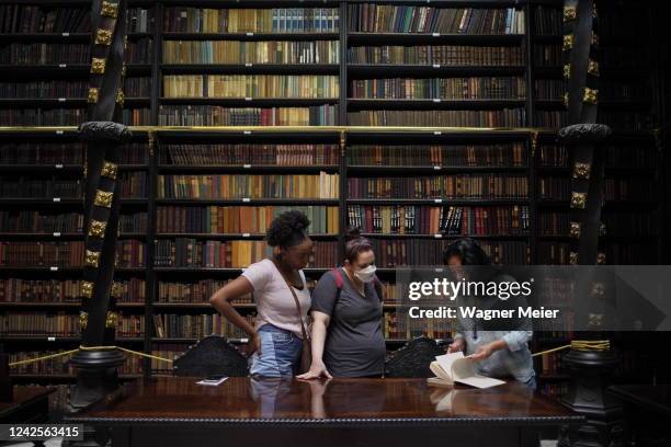 Tourists look books inside of the Royal Portuguese Cabinet of Reading on August 5, 2022 in Rio de Janeiro, Brazil. The shelves of this iconic...