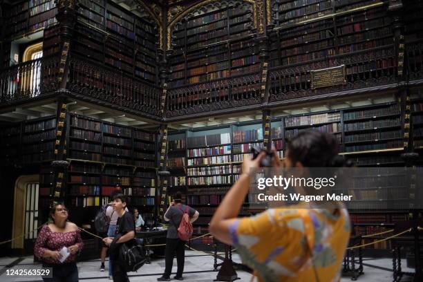 Tourists take pictures inside of the Royal Portuguese Cabinet of Reading on August 5, 2022 in Rio de Janeiro, Brazil. The shelves of this iconic...