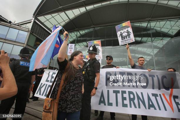 Protester carrying a Transgender pride flag confronts Patriotic Alternative supporters who oppose the drag queen story hour outside the Forum library...