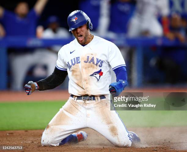 George Springer of the Toronto Blue Jays celebrates after scoring a run on a double by Santiago Espinal in the seventh inning against the Baltimore...