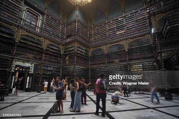 Tourists take pictures inside of the Royal Portuguese Cabinet of Reading on August 5, 2022 in Rio de Janeiro, Brazil. The shelves of this iconic...