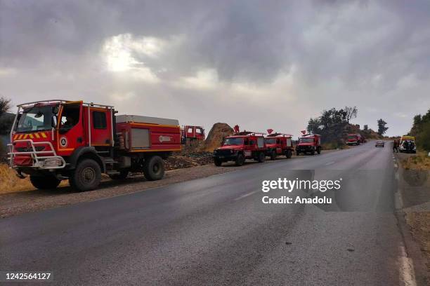 Fire trucks are seen during the firefighters intervene by land to control a wildfire in Setif, Algeria on August 17, 2022. In a statement on Algerian...