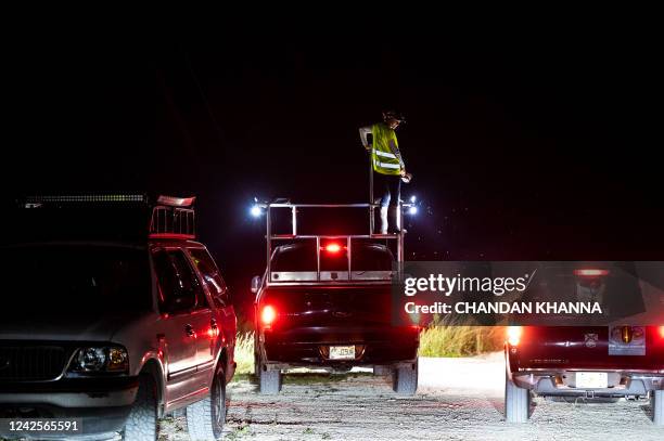 Professional python hunter, hired by the Florida Fish and Wildlife Conservation Commission searches for Burmese pythons, in Everglades National Park,...