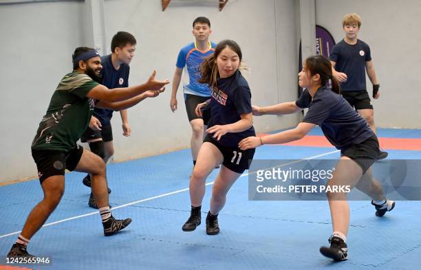 This picture taken on May 23, 2022 shows participants playing kabaddi, a tag-wrestling sport popular in South Asia which involves players trying to...