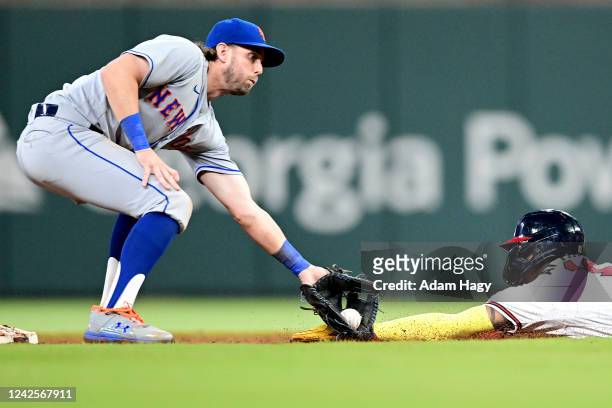 Jeff McNeil of the New York Mets tags out Ronald Acuna Jr. #13 of the Atlanta Braves during the seventh inning at Truist Park on August 17, 2022 in...