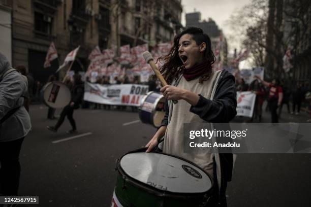 Young woman demonstrates plays the bass drum in the demonstration against economic adjustments in Buenos Aires, Argentina on Aug. 17, 2022. Against...