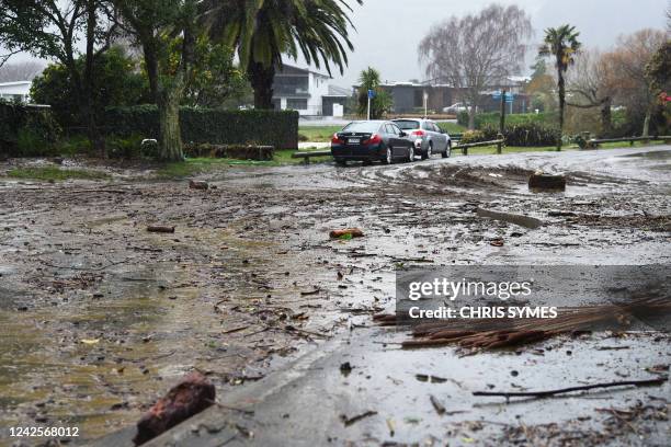 Debris is seen left strewn on a street in Nelson on August 18 after the city experienced flash floods caused by a storm. - Hundreds of families on...