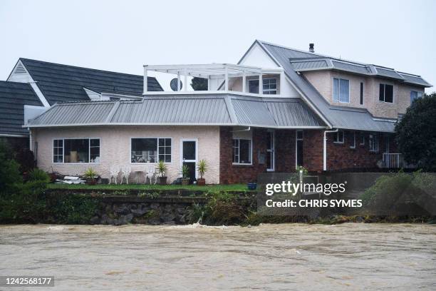 Home is seen next to the Maitai river after it burst its banks in Nelson on August 18 as the city experienced flash floods caused by a storm. -...