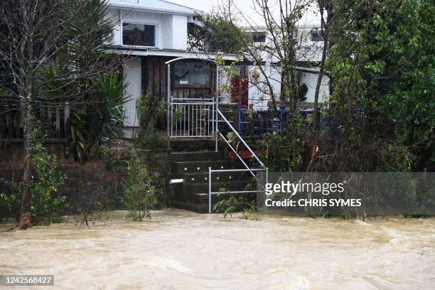 Water from the Maitai river is seen leading up to stairs of a property after the river burst its banks in Nelson on August 18 as the city experienced...