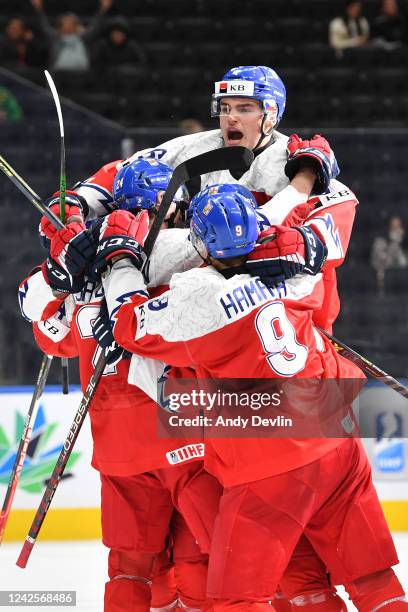 Ales Cech, Tomas Hamara and Matyas Sapovaliv of Czechia celebrate after a goal during the game against United States in the IIHF World Junior...