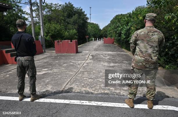 South Korea and US soldiers stand guard in front of the Bridge of No Return near the site of the 1976 "Axe Murder Incident" during a memorial...