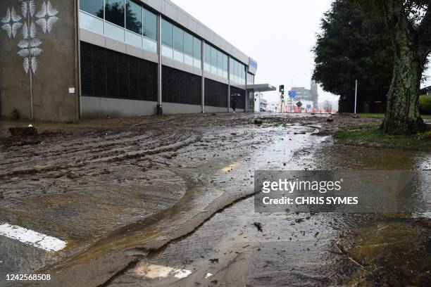 Mud is seen on the road after the Maitai river burst its banks in Nelson on August 18 as the city experienced flash floods caused by a storm. -...