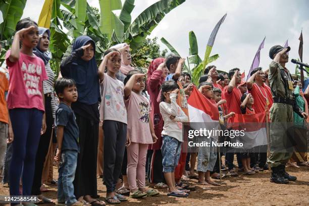 Residents salute to the Indonesian national flag during a ceremony to mark the 77th Indonesian Independence Day in Bogor, West Java, Indonesia, on...