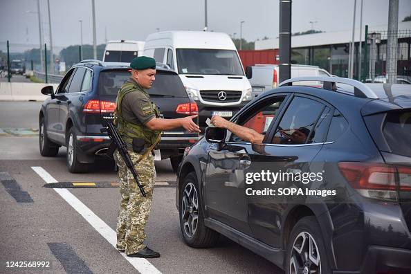Border Check A border guard checks documents at the newly renovated checkpoint on ...