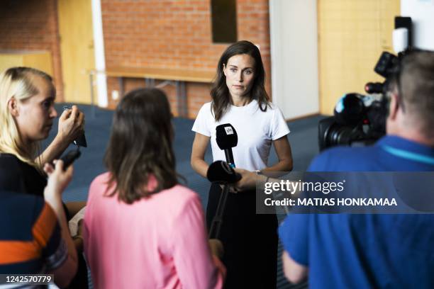 Prime Minister of Finland Sanna Marin answers journalists' questions on August 18, 2022 in Kuopio, Finland before the start of the Social Democratic...