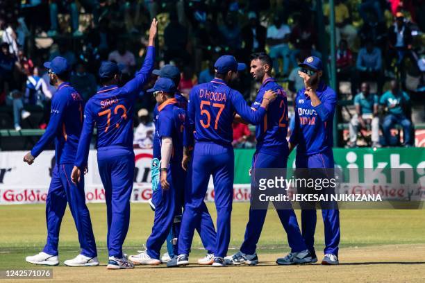 India's Prasidh Krishna celebrates with teammates after the dismissal of Zimbabwe's Ryan Burl during the first one-day international cricket match...