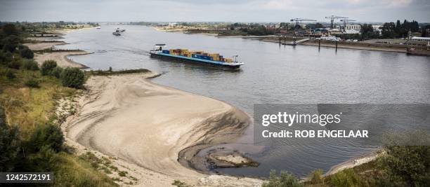 An aerial photo shows a barge sailing along the drought-hit River Rhine, where the water level has fallen to 6.48 meters above Normaal Amsterdams...