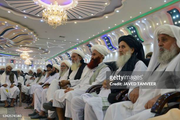 Taliban religious scholars attend a public meeting on economic welfare at a private salon in Kandahar on August 18, 2022.