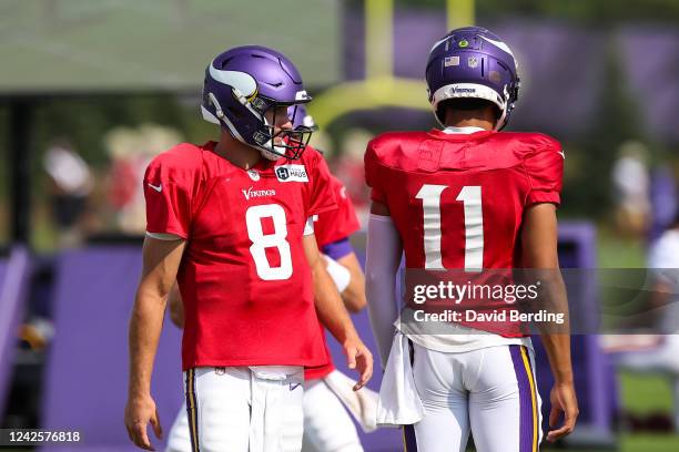 Kirk Cousins and Kellen Mond of the Minnesota Vikings look on during a joint practice with the San Francisco 49ers at training camp at TCO...