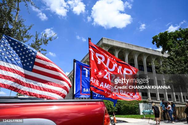 Supporters of former US President Donald Trump drive around the Paul G. Rogers Federal Building & Courthouse as the court holds a hearing to...
