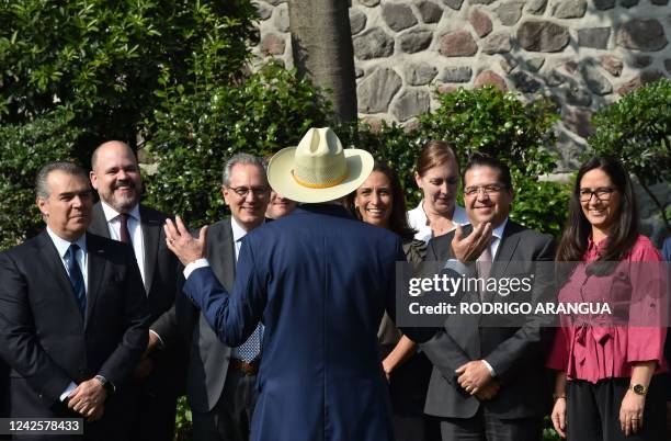 Ambassador to Mexico, Ken Salazar, talks to Mexican business people before offering a press conference at his residence in Mexico City on August 18,...