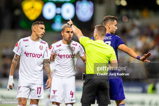 Cristian Manea of CFR Cluj reacts with head referee Pavel Orel during the UEFA Europa Conference League Qualifier Leg One match between NK Maribor...