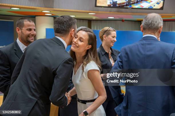 Sanna Marin Prime minister of Finland as seen at the European Council Round Table - Tour de Table room saluting Eduard Heger Prime Minister of...