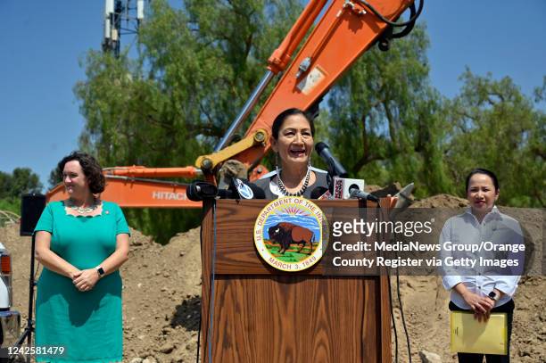 Irvine, CA U.S. Secretary of the Interior Deb Haaland, center, addresses the media as she stands with Congresswoman Katie Porter , left, and Camille...