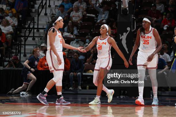 Brionna Jones high fives DiJonai Carrington of the Connecticut Sun during Round 1 Game 1 of the 2022 WNBA Playoffs on August 18, 2022 at Mohegan Sun...