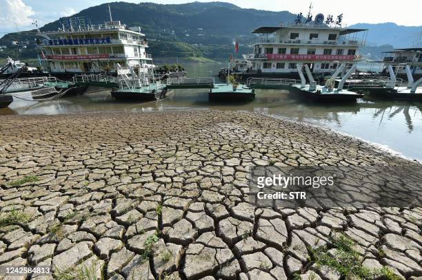 This photo taken on August 16, 2022 shows a section of a parched river bed along the Yangtze River in China's southwestern Chongqing. - China OUT /...