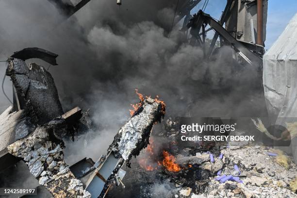 This photograph taken on August 19, 2022 shows a burning building of a chemical factory destroyed following a missile strike in the second largest...