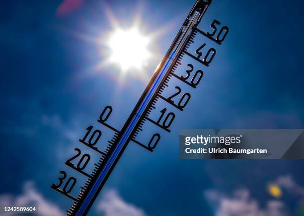 The illustration photo shows a thermometer with a high celsius degree display in front of the glaring sun on August 19, 2022 in Bonn, Germany. Hot...