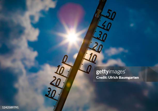 The illustration photo shows a thermometer with a high celsius degree display in front of the glaring sun on August 19, 2022 in Bonn, Germany. Hot...