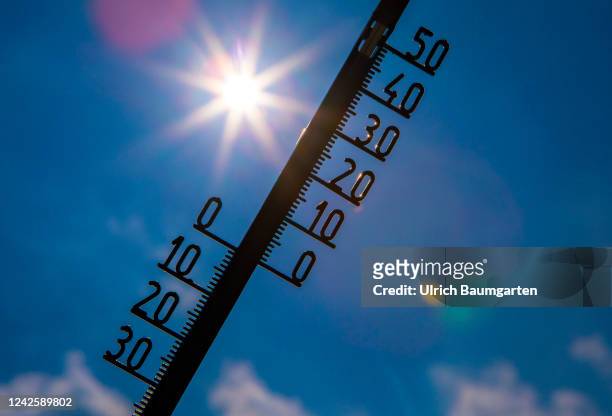 The illustration photo shows a thermometer with a high celsius degree display in front of the glaring sun on August 19, 2022 in Bonn, Germany. Hot...