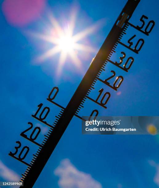 The illustration photo shows a thermometer with a high celsius degree display in front of the glaring sun on August 19, 2022 in Bonn, Germany. Hot...