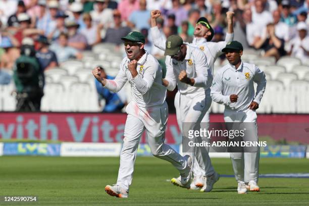 South Africa's Dean Elgar and teammates celebrate after England's James Anderson is bowled by South Africa's Marco Jansen to wrap up the game on day...
