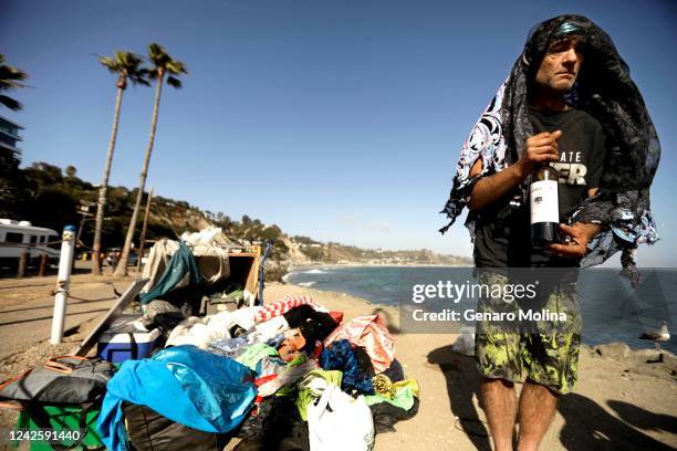 Phillip Krohn who lives homeless on a bluff above the Pacific Ocean, wears fabric to protect him from the sun along Pacific Coast Highway near Sunset...