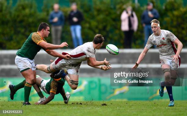 Jack Bennett of England U18 offloads the ball to Tom Burrow of England U18 during the U18 International Series match between South Africa and England...