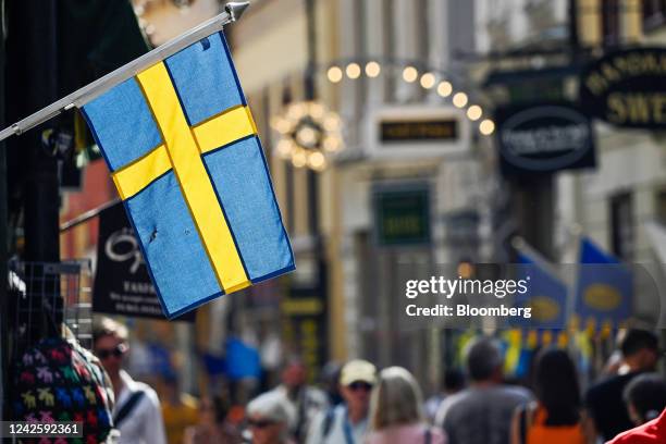 Swedish national flag hanging from a shop in Gamla Stan in Stockholm, Sweden, on Thursday, Aug. 18, 2022. Swedens government forecast the economic...