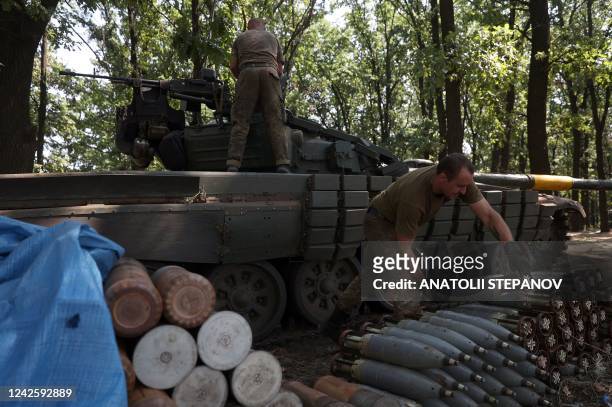 Ukrainian tankers load munition shells onto their tank at the front line in the Donetsk region on August 19 amid Russia's invasion of Ukraine.