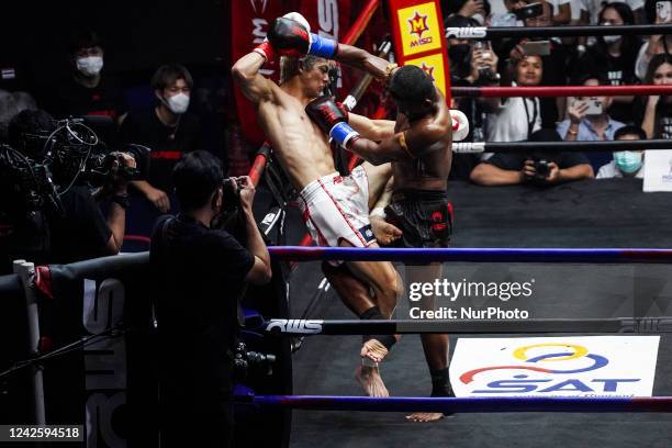 Buakaw Banchamek of Thailand and Kota Miura of Japan in action during will fight in a kickboxing exhibition or boxing show at Rajadamnern Stadium in...