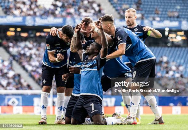 Patric Pfeiffer of SV Darmstadt 98 celebrates with teammates after scoring his team's first goal during the Second Bundesliga match between Hamburger...