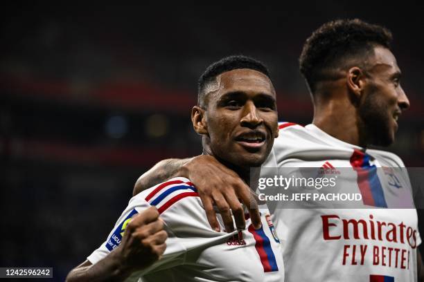 Lyons Brazilian forward Tete celebrates with teammate after scoring his team's third goal during the French L1 football match between Olympique...