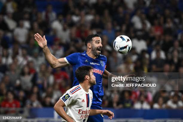 Troyes French defender Adil Rami fights for the ball with Lyons Argentinian defender Nicolas Tagliafico during the French L1 football match between...